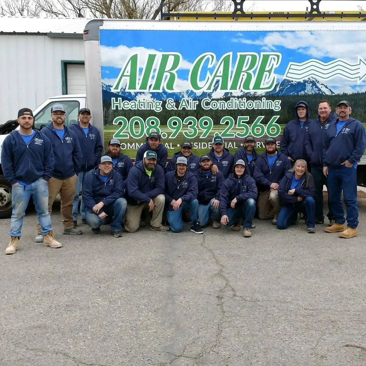 Air Care technicians and office staff in front of a company box truck